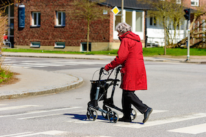 Elderly woman crossing the street