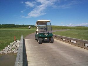 golf cart on golf course bridge