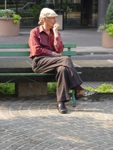 man sitting alone on park bench