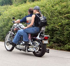 man and woman riding a motorcycle